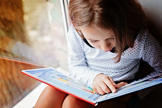 young child reading a book